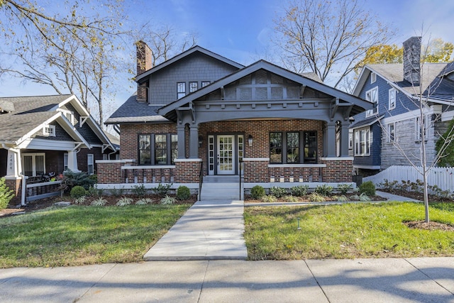 craftsman-style house featuring a porch and a front yard