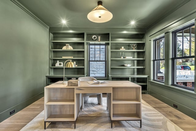 office area featuring crown molding, built in features, and light wood-type flooring