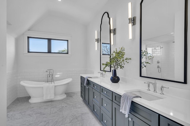 bathroom with vanity, vaulted ceiling, and shower with separate bathtub