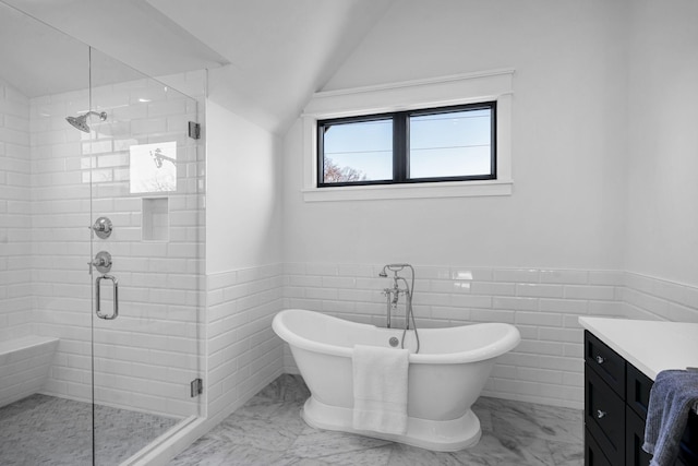 bathroom featuring vanity, separate shower and tub, and vaulted ceiling