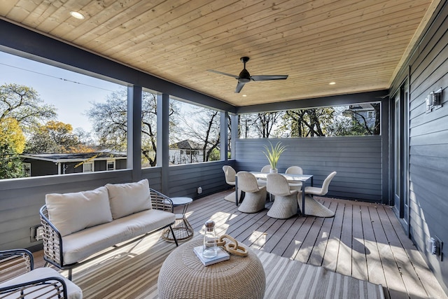 sunroom with ceiling fan and wooden ceiling