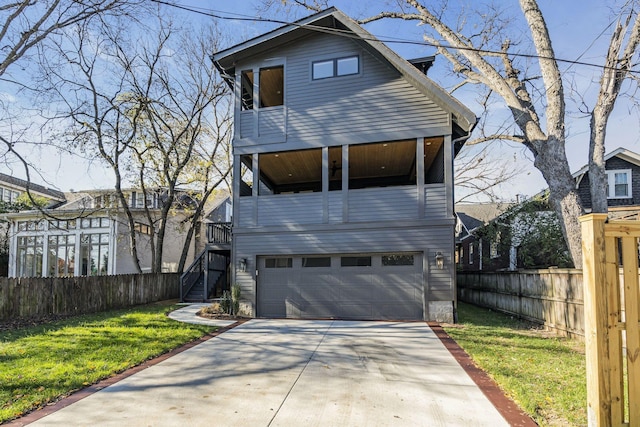 contemporary house featuring a balcony, a front lawn, and a garage