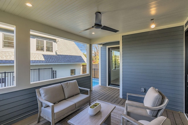 wooden terrace featuring outdoor lounge area and ceiling fan