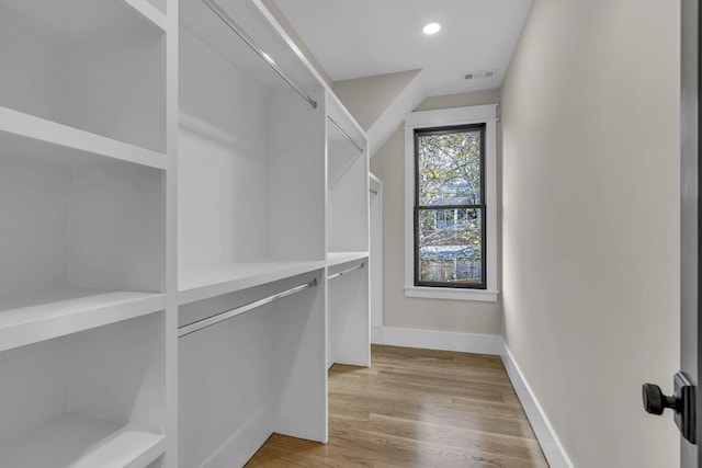 spacious closet with light hardwood / wood-style floors