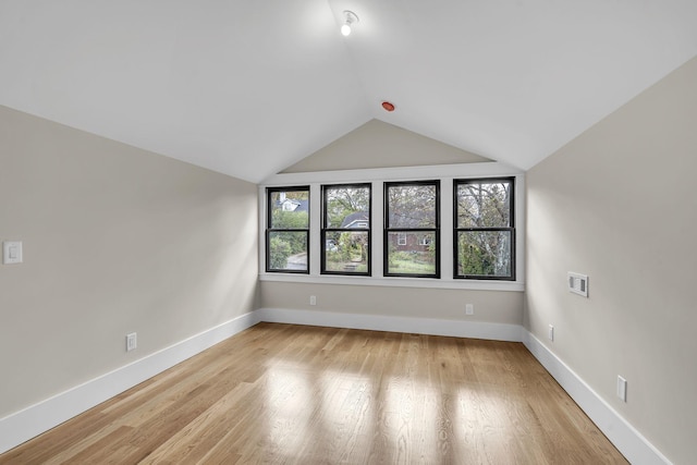 bonus room featuring light wood-type flooring and lofted ceiling