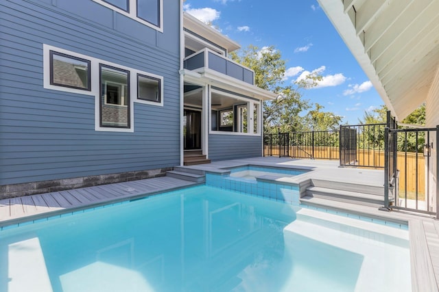 view of swimming pool featuring an in ground hot tub