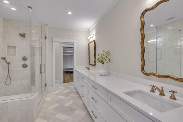 bathroom with vanity, an enclosed shower, and crown molding