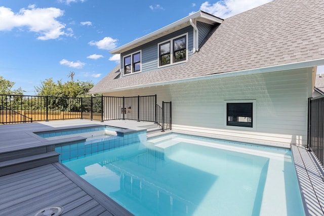 view of swimming pool featuring an in ground hot tub