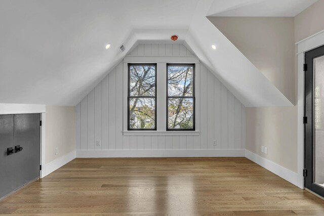 bonus room with light hardwood / wood-style floors and lofted ceiling