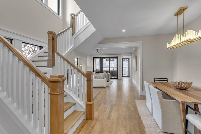 foyer entrance with a chandelier, a healthy amount of sunlight, and light hardwood / wood-style floors