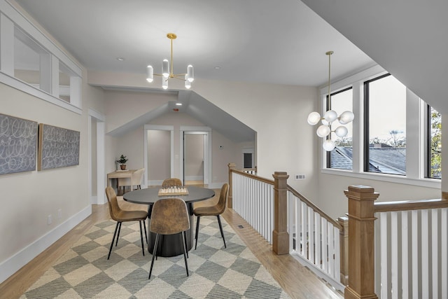 dining space featuring light hardwood / wood-style floors and a notable chandelier