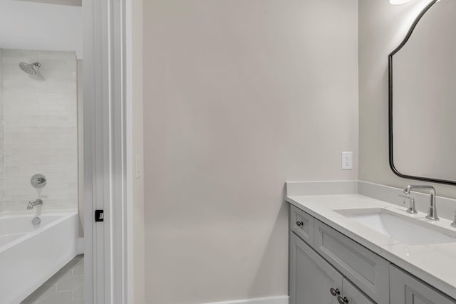 bathroom featuring vanity and tiled shower / bath