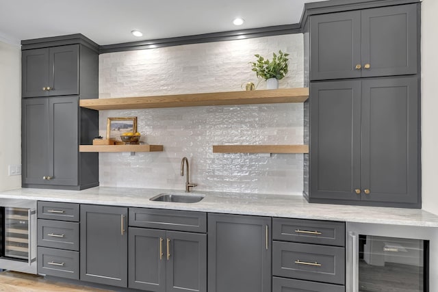 kitchen with gray cabinetry, sink, and wine cooler