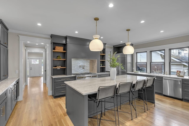 kitchen with dishwasher, decorative light fixtures, a center island, and gray cabinets