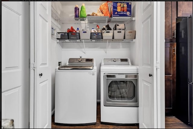 laundry area featuring dark hardwood / wood-style flooring and washing machine and dryer