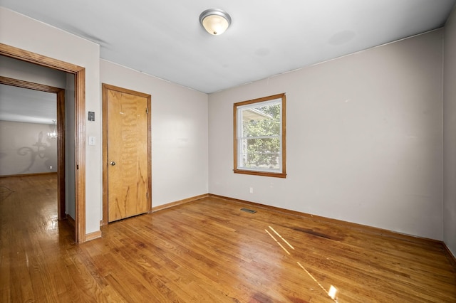 spare room with hardwood / wood-style flooring