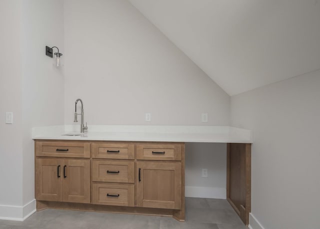 bathroom featuring vanity and lofted ceiling