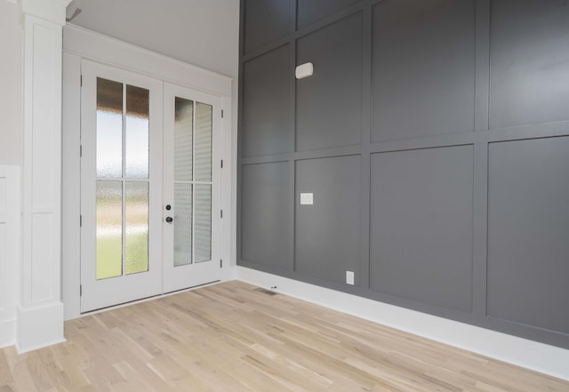 interior space with french doors and light hardwood / wood-style flooring