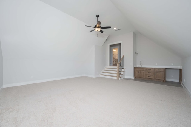 bonus room featuring ceiling fan, light carpet, and vaulted ceiling