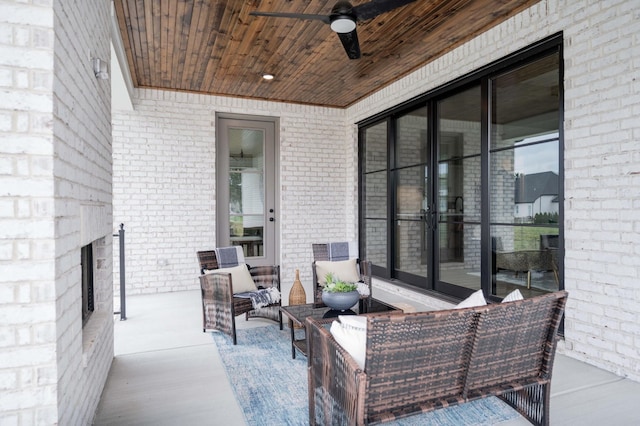 view of patio / terrace featuring an outdoor living space with a fireplace and ceiling fan