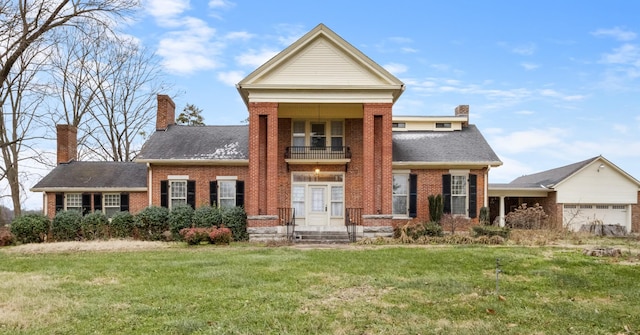 view of front of property with a balcony and a front lawn