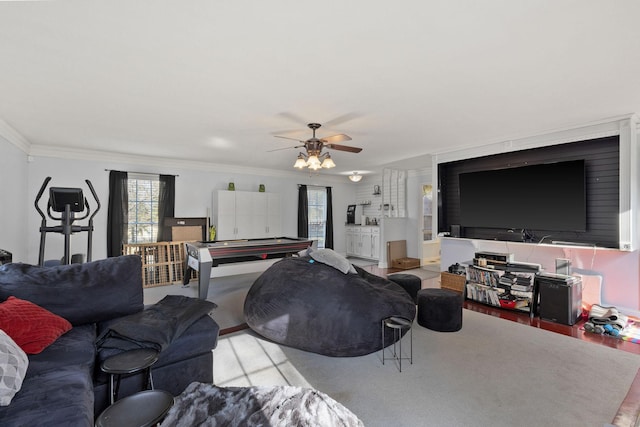 living room with ceiling fan and ornamental molding