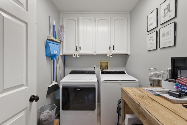 laundry room featuring cabinets and washer and dryer