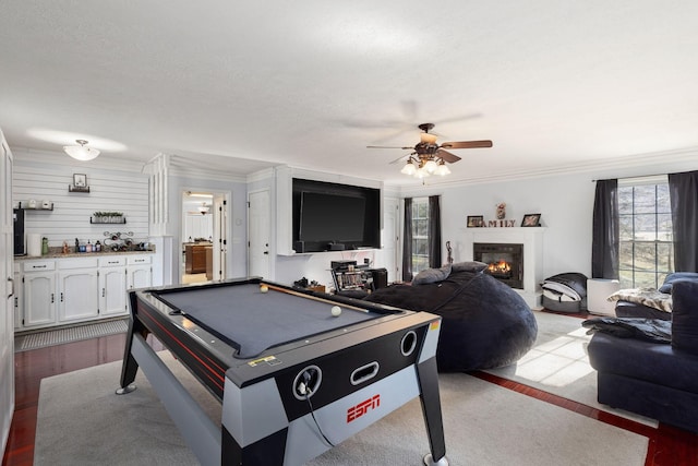 recreation room featuring ceiling fan, ornamental molding, a healthy amount of sunlight, and billiards