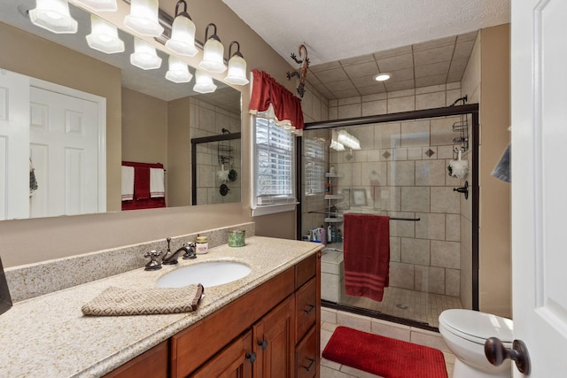 bathroom with toilet, vanity, tile patterned floors, and a shower with shower door