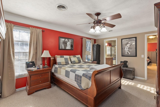 carpeted bedroom with ensuite bathroom, ceiling fan, a textured ceiling, and ornamental molding