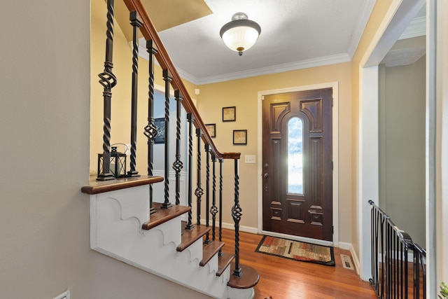 foyer entrance featuring hardwood / wood-style flooring and ornamental molding