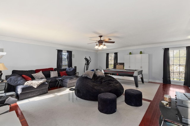 living room featuring dark hardwood / wood-style floors, a wealth of natural light, ornamental molding, and ceiling fan