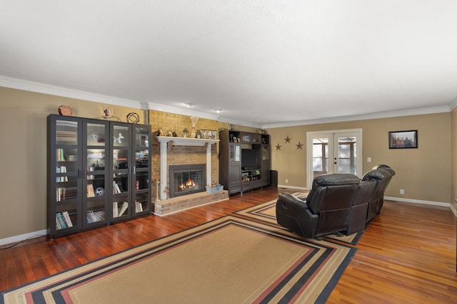 living room with a fireplace, ornamental molding, french doors, and hardwood / wood-style flooring