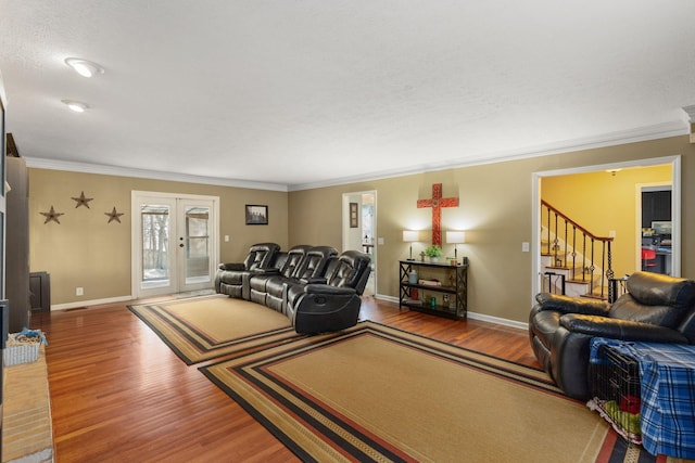 living room with crown molding, french doors, and wood-type flooring