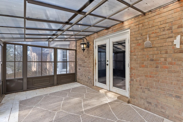 unfurnished sunroom with french doors and coffered ceiling