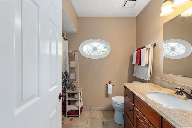 bathroom with tile patterned flooring, vanity, toilet, and a shower with shower curtain