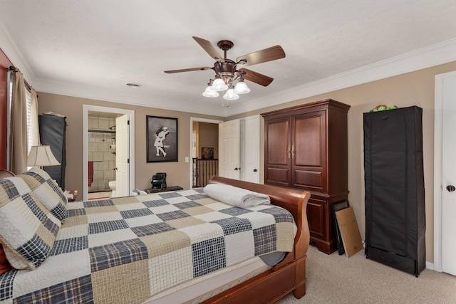 bedroom featuring ensuite bath, a textured ceiling, light colored carpet, ceiling fan, and crown molding