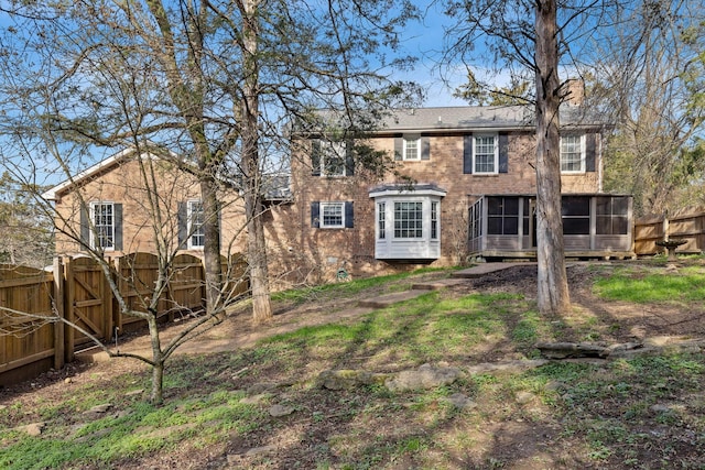 back of house featuring a sunroom