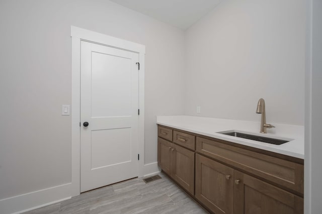 bathroom with wood-type flooring and sink