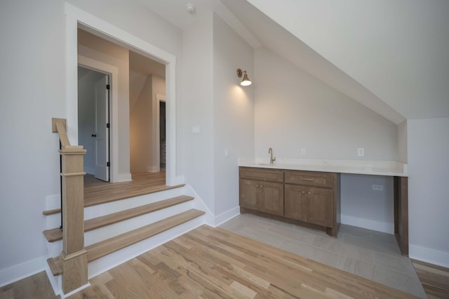 interior space with vaulted ceiling and sink