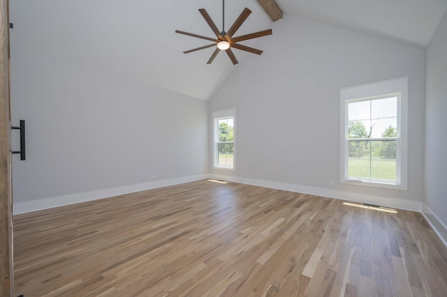 unfurnished room with ceiling fan, beam ceiling, light wood-type flooring, and high vaulted ceiling