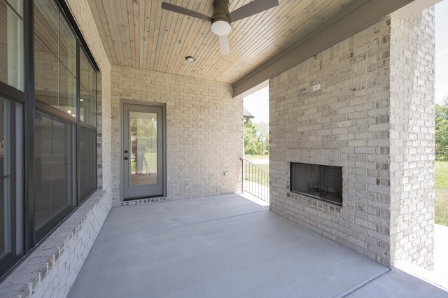 view of patio / terrace with ceiling fan and an outdoor brick fireplace