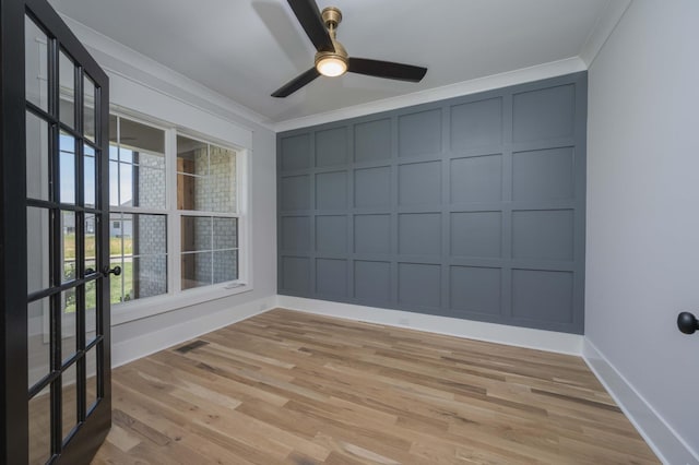 empty room with light wood-type flooring, a wealth of natural light, and ornamental molding