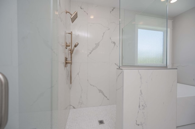 bathroom with a tile shower