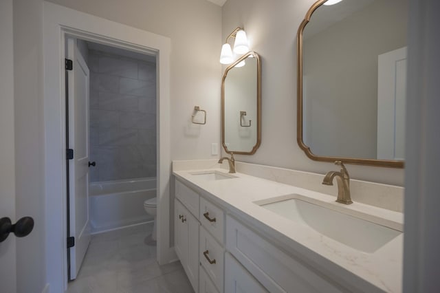 full bathroom featuring tiled shower / bath, tile patterned flooring, vanity, and toilet