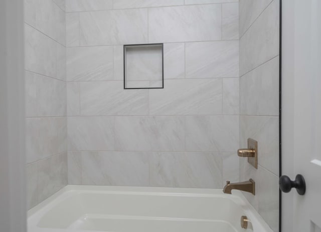 bathroom with tiled shower / bath combo