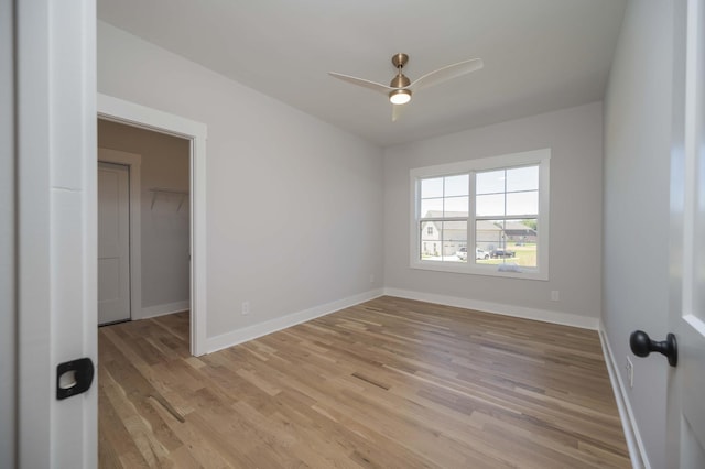 spare room with ceiling fan and light wood-type flooring