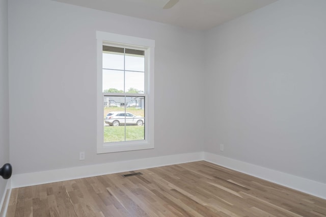 spare room with a healthy amount of sunlight and light hardwood / wood-style floors