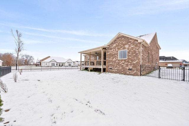 view of snow covered rear of property