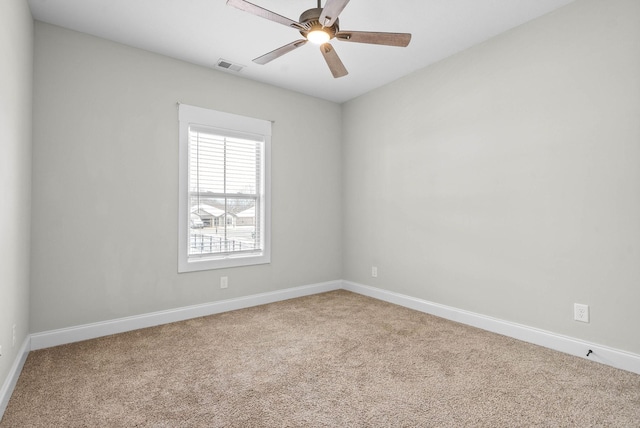 carpeted spare room with ceiling fan